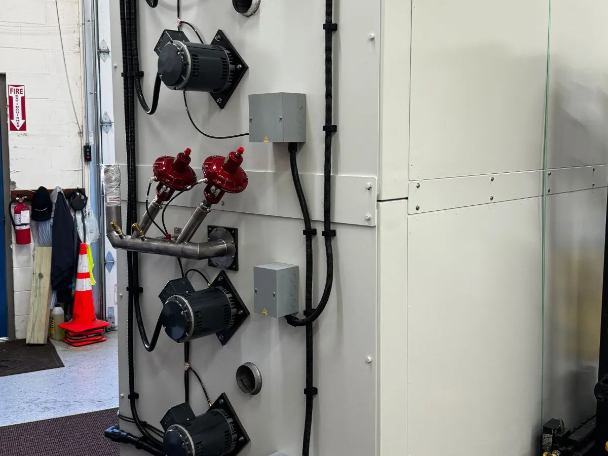 Back of a new chamber with two red vacuum-jacketed proportional LN2 valves on a stainless manifold between the blower motors